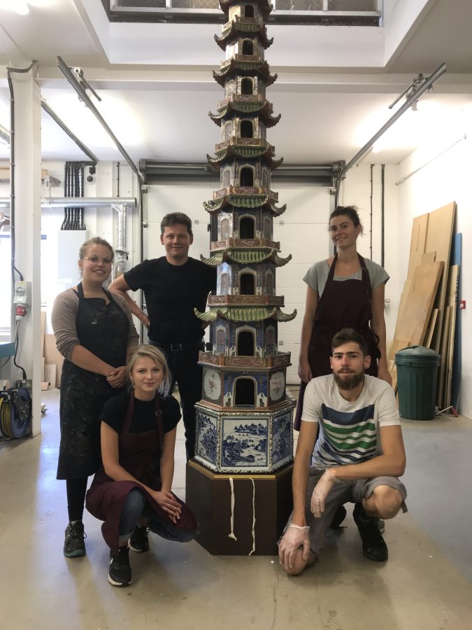 The Yannick Chastang Conservation team in 2018 in front of a large porcelain pagoda during conservation
